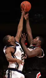 Juan Palacios, right, puts up a shot against Pittsburgh's Sam Young in the first half.