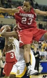 Helen Johnson goes up to block the shot of Marquette's Jasmine McCullough during the second half.  (AP Photo/ Ron Kuenstler)