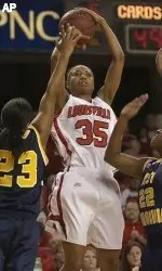 Angel McCoughtry puts up a shot between the defense of West Virginia's Ashley Powell and Chakhia Cole during the second half.