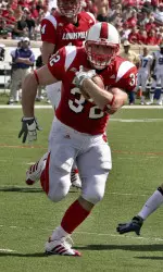 Running back Brock Bolen (32) splits Tennessee Tech defenders to score the first touchdown of the season in the first quarter. (AP Photo/Garry Jones)