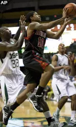 Louisville guard Edgar Sosa (10) drives to the basket past South Florida forward Mobolaji Ajayi (33) during the first half. (AP Photo/Steve Nesius)