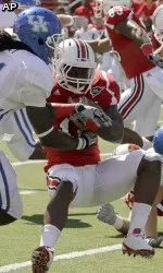 Louisville running back Bilal Powell looks for running room against Kentucky's Mychal Bailey. (AP Photo/Garry Jones)