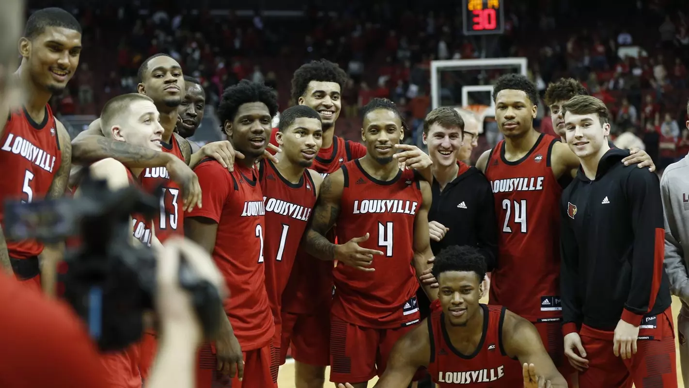 Cardinal men's basketball team celebrates after a win over Notre Dame on Senior Day