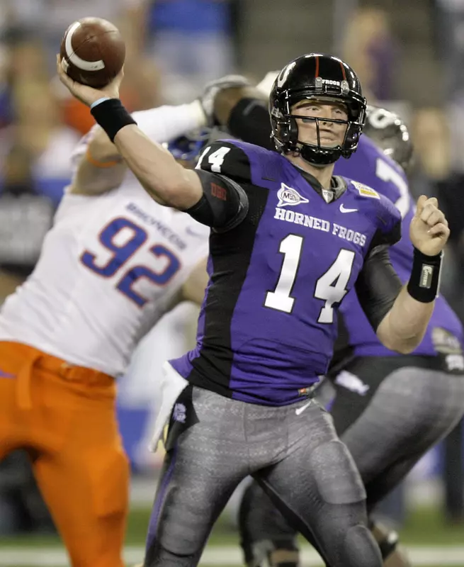 TCU quarterback Andy Dalton (14) throws as Boise State defensive end Shea McClellin (92) pursues during the first quarter of the Fiesta Bowl NCAA college football game Monday, Jan. 4, 2010, in Glendale, Ariz. (AP Photo/Paul Connors)