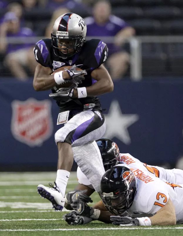 TCU wide receiver Skye Dawson attempts to escape the grasp of Oregon State linebackers Rueben Robinson and Dwight Roberson.