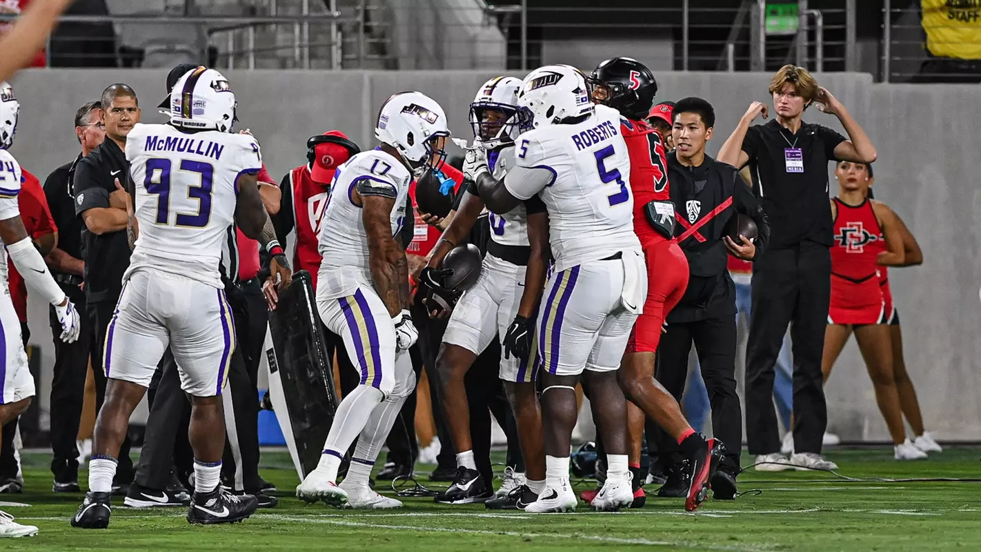 DJ Kelly celebrates with teammates after his interception at San Diego State on Sept. 19.