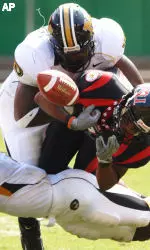 Arkansas State receiver Gary Vincent fumbles the ball after he is hit by Lorenzo Williams.
