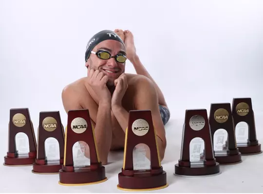 Nick Albiero poses with his senior year NCAA trophies.