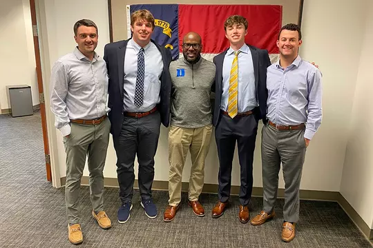 Former Blue Devil Terrell Smith, who runs the Futures Initiatives, flanked by Blue Devil players.
