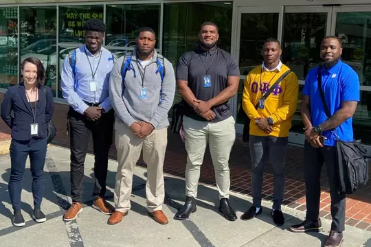 Duke football players RJ Oben, Maurice McIntyre, Jacob Monk, and Sahmir Hagans with Duke staffer Dorian Jackson during their summer immersion in Wake County (NC) government
