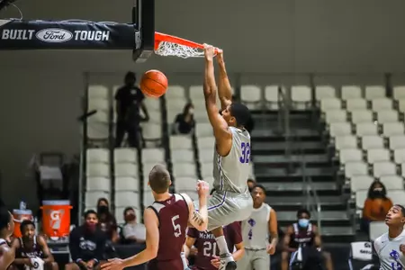 Joe Pleasant throws down a dunk over a McMurry player on Dec. 12