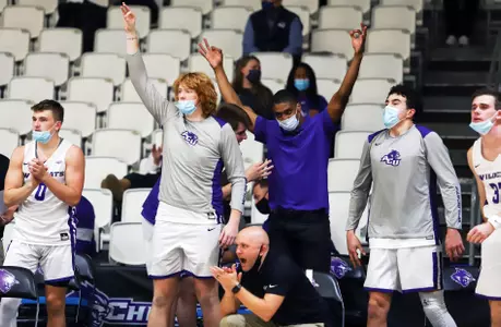 Wildcats celebrate on the sideline against HPU