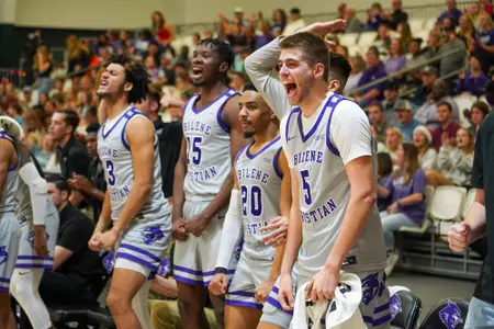 Bench celebrates a play in a dominant win over UIW