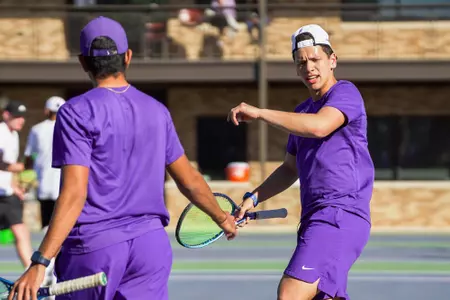 Riley Tran (facing) celebrates with his doubles partner.
