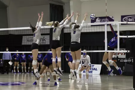 Kate Blasingame, Breanna Box, and Sarah Nading put up a block against UTA