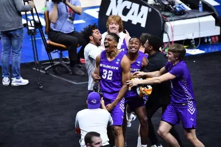 Joe Pleasant is surrounded by teammates following ACU's NCAA first-round win over Texas