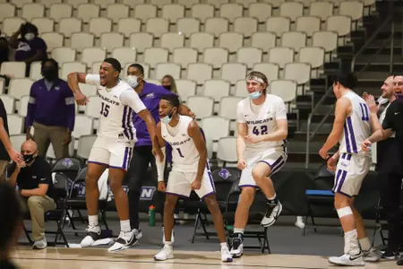 Wildcats bench celebrates against HPU