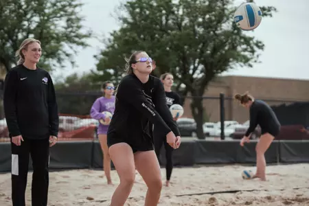Claire Dunn passes during beach practice