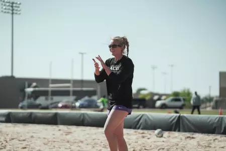 Hunter Barker cheers on her teammates at beach practice