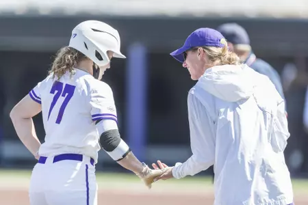 Val Rudd talks to coach Farler after hitting a triple against UCA