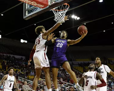 Coryon Mason drives under the basket against NM State