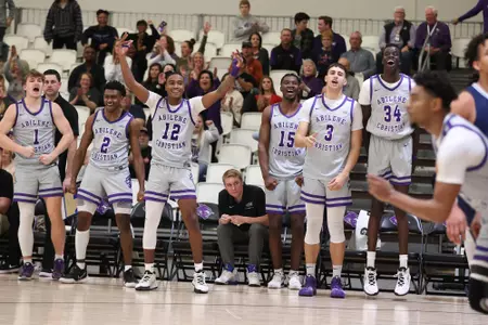 Wildcat bench celebrates a made basket in a win over CBU