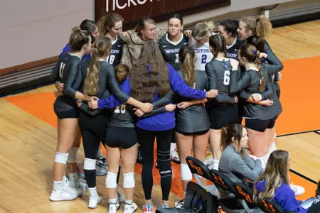 Alisa Blair addresses her team in a pregame huddle on the sidelines at Sam Houston