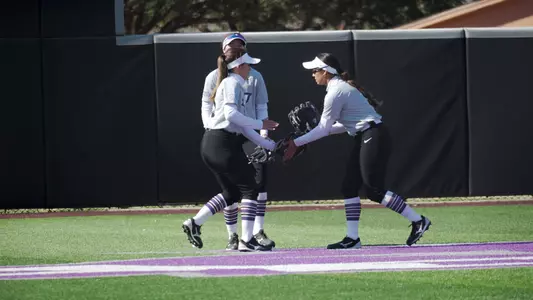 Outfielders shake hands prior to an inning starting