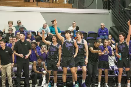 Wildcats bench celebrates a made three on the road at Tarleton