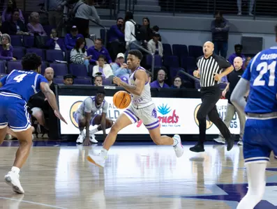 Damien Daniels brings the ball up the court in a win over UT Arlington at home