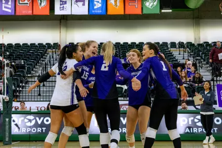 team coming together in huddle after point