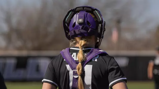 Sydney Kaiser stands at home plate in catchers gear