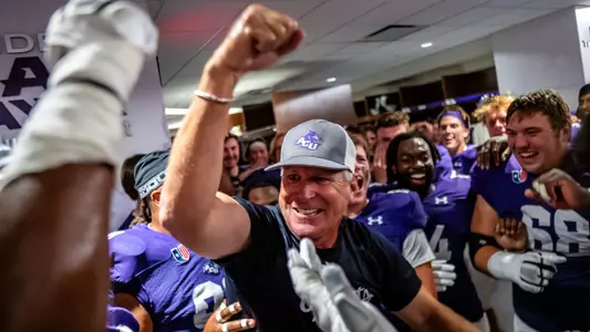 Head coach Keith Patterson celebrates in the locker room after a4 1-34 win over Central Arkansas on Oct 5, 2024