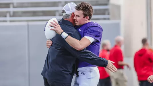Coach Keith Patterson hugs quarterback Maverick McIvor on Senior Day November 2, 2024