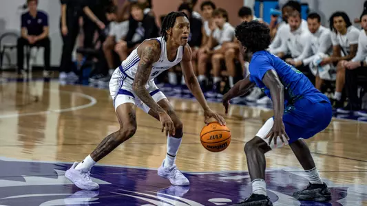 Rich Smith dribbles against a defender vs Texas A&M-Corpus Christi