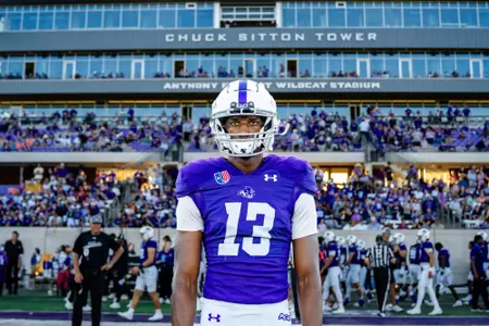 Blayne Taylor in front of Chuck Sitton Tower