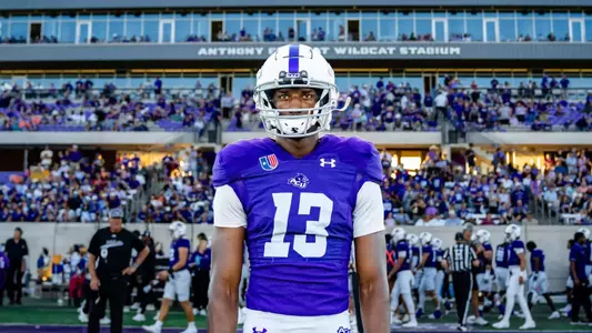 Blayne Taylor in front of Chuck Sitton Tower