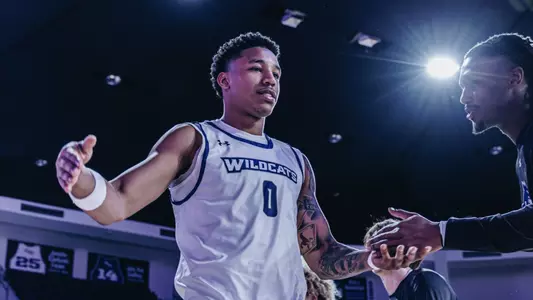 Zy Wright slaps hands during starting lineup introductions before playing McMurry on November 3, 2025