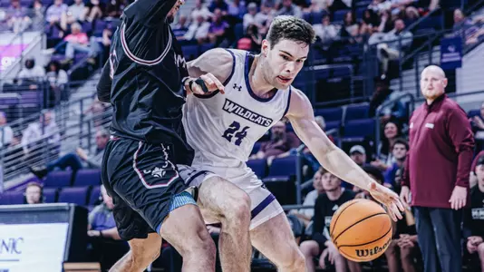 Isaac Dye dribbles around a McMurry defense on November 3, 2025