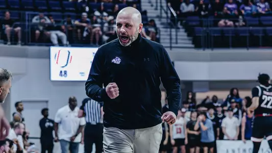 ACU head coach Brette Tanner pumps his fist during a win against Omaha