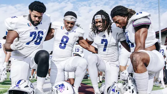 ACU players Joziah Fogle, Jeshari Houston, Javon Gipson and Rashon Myles, Jr. pray before playing at Eastern Kentucky