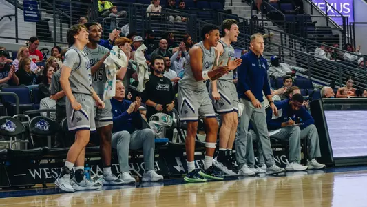 ACU basketball players cheer from the bench against Jarvis Christian on November 28, 2025
