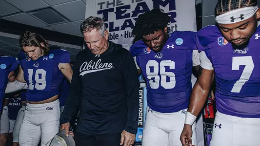 ACU head coach Keith Patterson prays in the locker room with Zack Haaland, Chidubem Lebechi and TJ Marshall after a win over Lamar on November 29, 2025