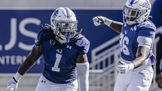 Will Shaffer celebrates with teammate Jailyn Gibbs against Lamar on November 29, 2025