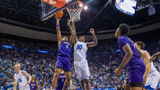 Zy Wright jumps to lay the ball off the backboard against a BYU defense on Dec. 19, 2025