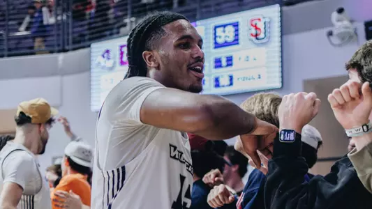 Bradyn Hubbard celebrates with fans after a win versus Seattle U