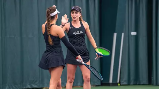 Hebe Toyos high-fives a teammate in ACU women's tennis' matchup with New Mexico at the Teague Center on Feb. 21, 2025.