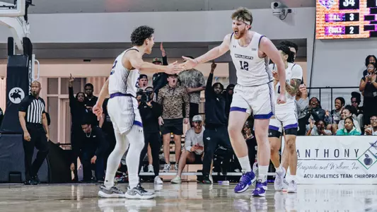 Cade Hornecker and Hunter Jack Madden slap hands in celebration