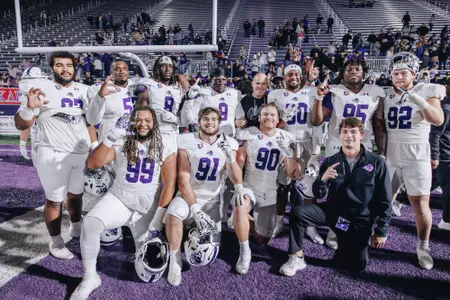 ACU defensive linemen celebrate the UAC championship win with coach Nick Holt