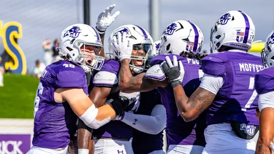 Izaiah Kelley is congratulated by teammates for an interception vs. Eastern Kentucky.